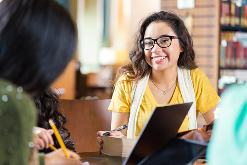 A student smiles while speaking with an admissions counselor.